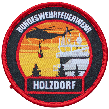 Abzeichen der Bundeswehrfeuerwehr Holzendorf mit Hubschrauber und Silhouette eines Turms.