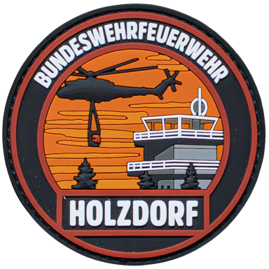 Abzeichen der Bundeswehrfeuerwehr Holzdorf mit Hubschrauber und Feuerwache.
