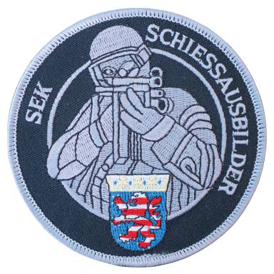 Runder Aufnäher mit einem Schützen und einem Wappen in Blau-Rot-Gelb.