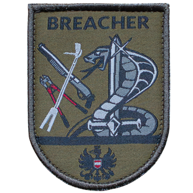 Abzeichen mit einer Schlange und Werkzeugen, beschriftet mit "BREACHER".