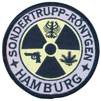 Wappen der Sondertrupp-Röntgen aus Hamburg mit Symbolen für Strahlenschutz und Waffe.