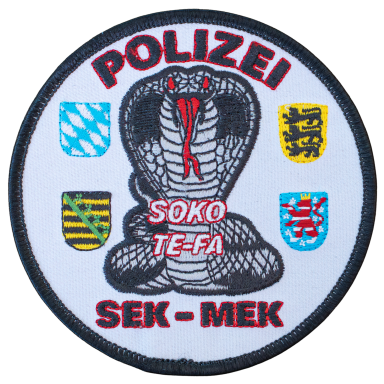 Abzeichen der Polizei mit einer Schlange und verschiedenen Wappen.
