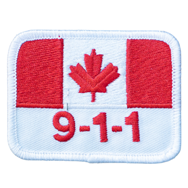 Rot-weißes Abzeichen mit der kanadischen Flagge und der Aufschrift „9-1-1“.