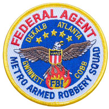 Abzeichen eines FBI-Agenten der Metro Armed Robbery Squad, mit Adler und Sternen.