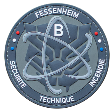 Logo der Sicherheitsabteilung von Fessenheim mit atomarem Symbol und blauem Ring.