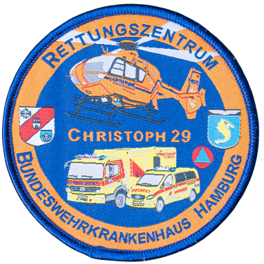Abzeichen des Rettungszentrums Christoph 29 mit Hubschrauber und Rettungsfahrzeugen.