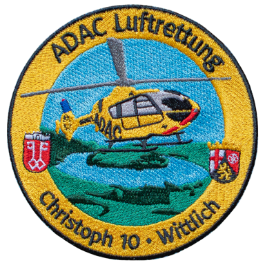 Abzeichen der ADAC Luftrettung, gelbes Hubschraubermotiv mit Standortinformationen.