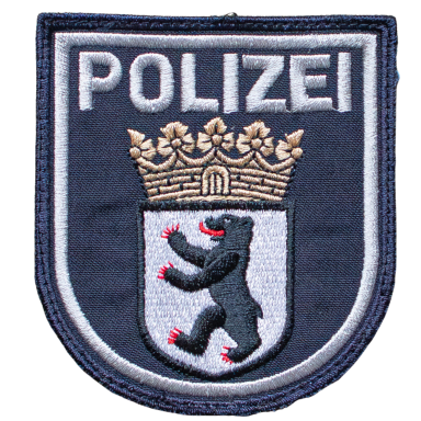 Wappen der Polizei mit einem Bären und einer Krone auf blauem Hintergrund.