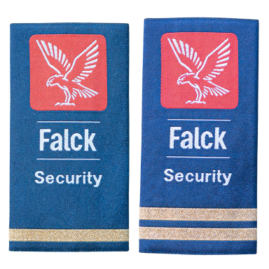 Zwei blaue Sicherheitspatente mit Falck-Logo und goldenen Streifen.