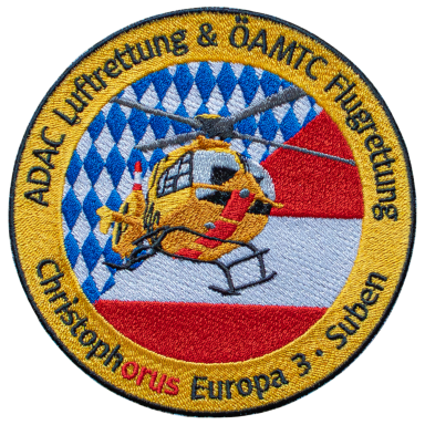 Wappen des ADAC Luftrettung mit einem Hubschrauber und bayerischem Muster.