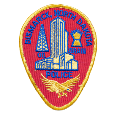 Wappen der Polizei von Bismarck, North Dakota, mit Gebäude- und Adlerdesign.